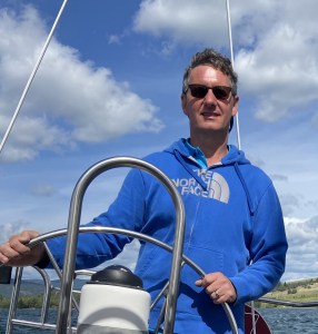 a man standing next to a boat
