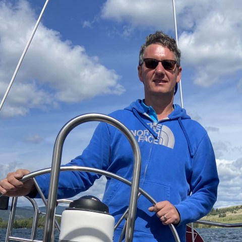 a man standing next to a boat