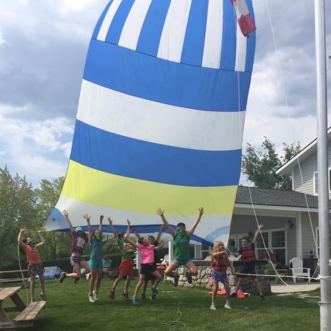 a group of people standing around a plane