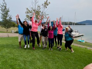 a group of people standing on top of a grass covered field