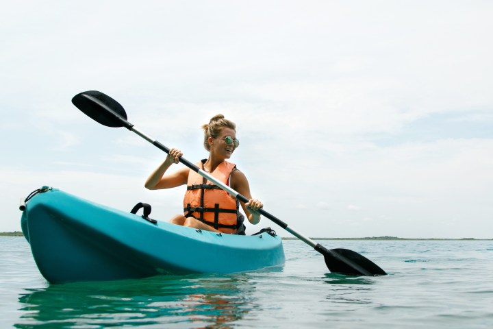 a person riding on the back of a boat in the water