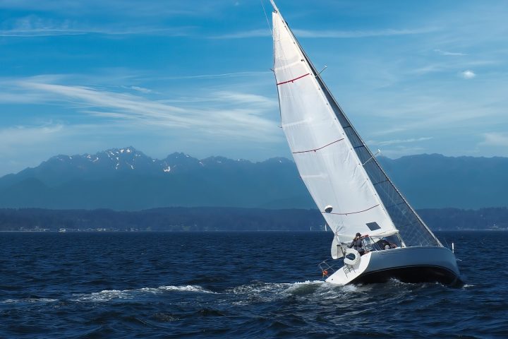 a boat on a body of water with a mountain in the background