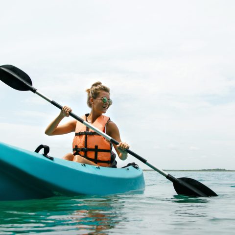 a person riding on the back of a boat in the water