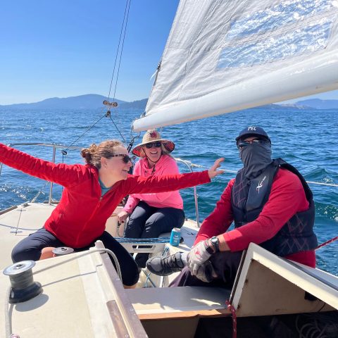 a man and a woman sitting on a boat in the water