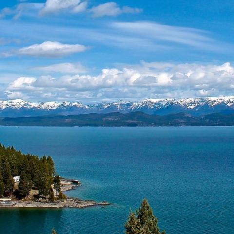 a large body of water with a mountain in the background